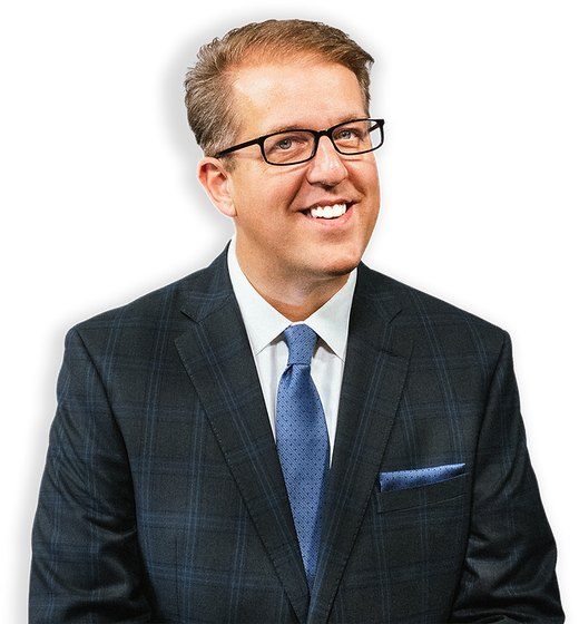Portrait of author Scott Miller in a dark checked suit and glasses.